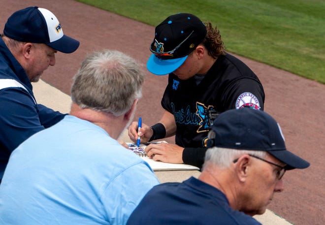 York Revolution's Jacob Rhinesmith (9) signing baseball cards at the Fan Fest at WellSpan Park in York on Saturday, Apr. 22, 2023.
