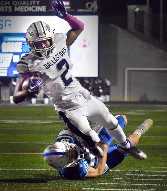 Dallastown running back Christopher Cromartie (2) is brought down by Spring Grove's Adam Herbst during a York-Adams Division I football game Friday, Oct. 20, 2023, in Spring Grove. The Wildcats spoiled the Rockets' homecoming with a 28-21 win.