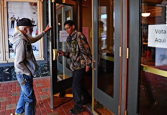 Juilo Marrero, left, of York City, opens the door to enter as Sophia Washington, also of York City, exits the Appell Center as each votes at their polling location during Election Day in York City, Tuesday, Nov. 7, 2023. (Dawn J. Sagert/The York Dispatch)