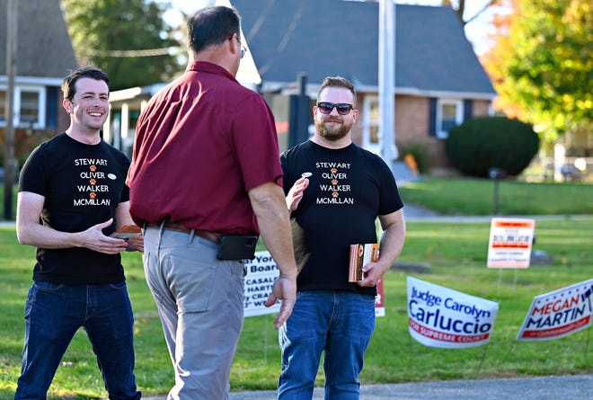 Central York School Board candidate Benjamin Walker, right, and supporter David Krebs, left, greet voters at the Commonwealth Fire Co No. 1 Station 893 polling location during Election Day in Springettsbury Township, Tuesday, Nov. 7, 2023. (Dawn J. Sagert/The York Dispatch)