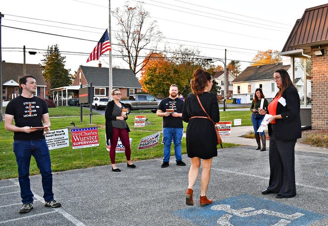 Candidates and supporters greet voters as they arrive at their Commonwealth Fire Co No. 1 Station 893 polling location during Election Day in Springettsbury Township, Tuesday, Nov. 7, 2023. (Dawn J. Sagert/The York Dispatch)