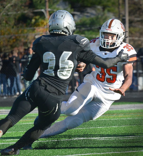 Central York's Baise Reedy (35) tries to shake Harrisburg's Deshaun Roman (26) on a kick return during Saturday's District 3 Class 6A semifinal football game in Harrisburg. The host Cougars held off a late charge to win 28-21 and end the Panthers' season.