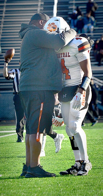 Central York's Carter Vaughn (4) and his father, Panthers assistant coach Fernando Vaughn, share a hug after Saturday's 28-21 loss at Harrisburg in the District 3 Class 6A semifinals. Vaughn was part of a senior class that won a playoff game in four consecutive seasons.