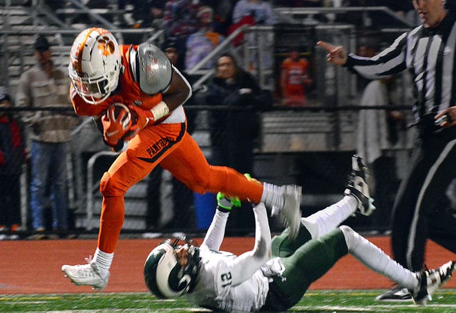 Central York's Juelz Goff runs over Central Dauphin's Mateo Crummel during the teams' District 3 Class 6A playoff game Friday, Nov. 10, 2023, in Springettsbury Township. Central York won, 42-34, in a back-and-forth battle.