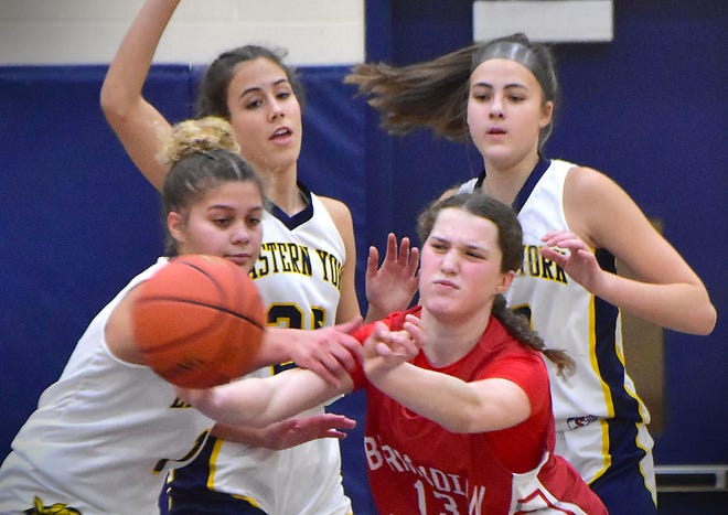Bermudian Springs' Lucy Peters (13) goes for the ball against three Eastern York players during the Eastern York Girls' Basketball Rotary Club Holiday Tournament in Wrightsville on Thursday, Dec. 28, 2023. The host Golden Knights beat the Eagles, 59-51, to win the title.