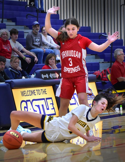 Bermudian Springs' Hannah Metzger (3) defends as Eastern York's Arianna Seitz slips on the floor during the Eastern York Girls' Basketball Rotary Club Holiday Tournament in Wrightsville on Thursday, Dec. 28, 2023. The host Golden Knights beat the Eagles, 59-51, to win the title.