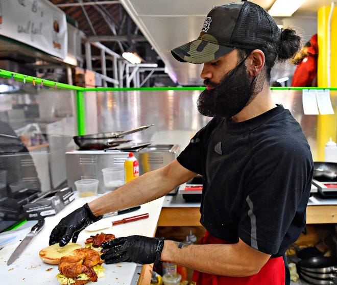 Owner Nathaniel Jamison builds a $5 breakfast sandwich at The Breakfast Store inside Penn Market in York City, Saturday, Feb. 17, 2024. (Dawn J. Sagert/The York Dispatch)