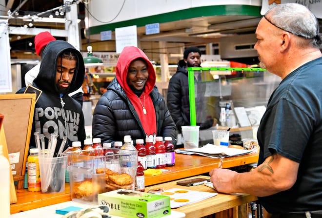 From right, Robert Merced assists customers Zyhir Shakir and King Miller, both of York City, at The Breakfast Store inside Penn Market in York City, Saturday, Feb. 17, 2024. (Dawn J. Sagert/The York Dispatch)