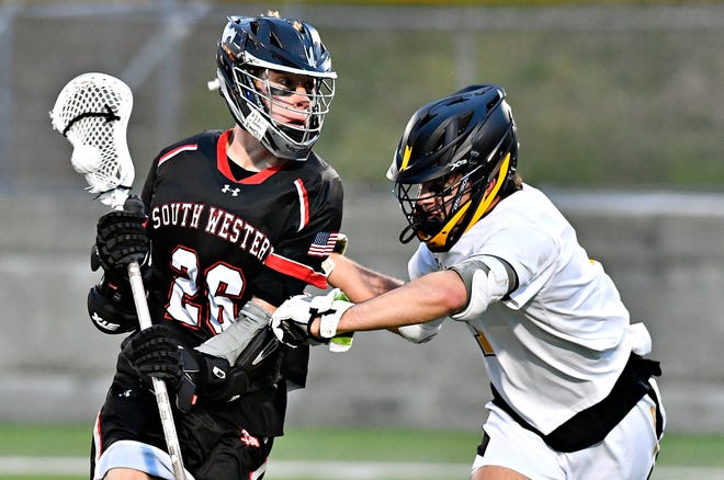 South Western’s Hunter Gray, left, moves the ball down the field while Red Lion’s Ty Heilman defends during boys’ lacrosse action at Red Lion Area Senior High School in Red Lion, Tuesday, March 26, 2024. South Western would win the game 14-4.(Dawn J. Sagert/The York Dispatch)