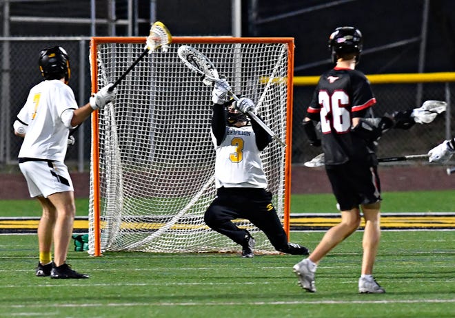 Red Lion’s Ethan Burkindine defends against a shot on goal by South Western during boys’ lacrosse action at Red Lion Area Senior High School in Red Lion, Tuesday, March 26, 2024. South Western would win the game 14-4.(Dawn J. Sagert/The York Dispatch)