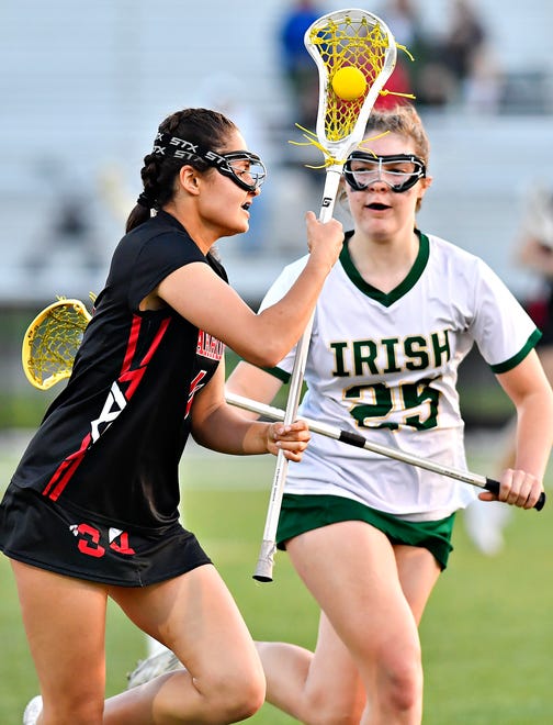 Susquehannock’s Sammi Madden controls the ball while York Catholic’s Katelyn Baker defends during girls’ lacrosse action at York Catholic High School in York City, Thursday, April 18, 2024. York Catholic would win the game 8-4. (Dawn J. Sagert/The York Dispatch)