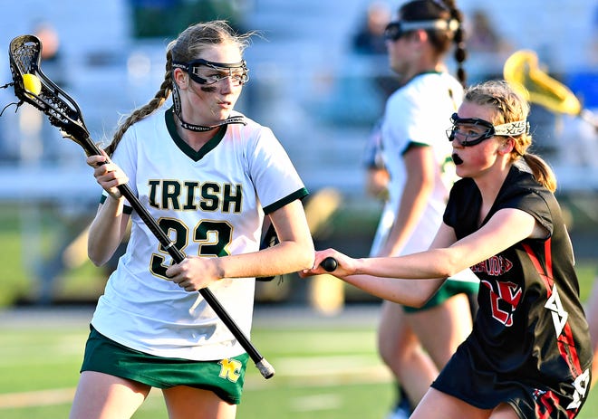York Catholic’s Sarah Perry, left, controls the ball while Susquehannock’s Sophie Sedgley defends at York Catholic High School in York City, Thursday, April 18, 2024. York Catholic would win the game 8-4. (Dawn J. Sagert/The York Dispatch)