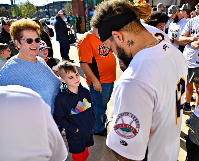 From left, Trena Stonebraker, of Manchester Township, and her grandson Cole Youngblood, 9, of Hellam Township, collect an autograph from York Revolution catcher Paul Mondesi during Fan Fest at WellSpan Park in York City, Saturday, April 20, 2024. (Dawn J. Sagert/The York Dispatch)