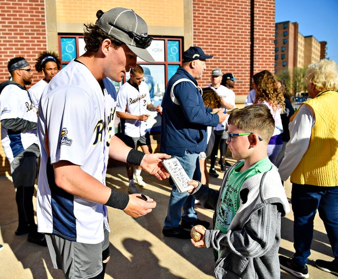 Maddox Bupp, 9, right, collects autographs from catcher Robert Chesney during York Revolution’s Fan Fest at WellSpan Park in York City, Saturday, April 20, 2024. (Dawn J. Sagert/The York Dispatch)