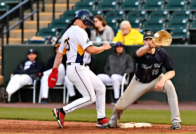 York Revolution’s Donovan Casey, left, jumps back to first as Mount Wolf’s Mark Burnside looks to catch the ball in a pickoff attempt at first in baseball action at WellSpan Park in York City, Saturday, April 20, 2024. (Dawn J. Sagert/The York Dispatch)