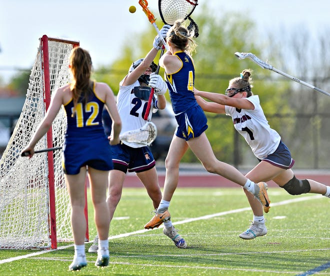 New Oxford’s Daelyn Hardnack defends as Eastern York’s Kiera Young makes a shot on goal during girls’ lacrosse action at New Oxford High School in Oxford Township, Tuesday, April 23, 2024. (Dawn J. Sagert/The York Dispatch)