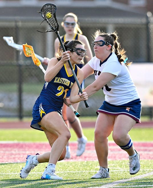 Eastern York’s Taylor Sawmiller, left, controls the ball while New Oxford’s Keira Linebaugh defends during girls’ lacrosse action at New Oxford High School in Oxford Township, Tuesday, April 23, 2024. (Dawn J. Sagert/The York Dispatch)