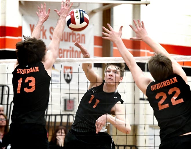 Central York's Braden Richard gets a slam past York Suburban's Nate Bowman, left, and John Doll during volleyball action at Suburban on Tuesday, April 2, 2019. Central won the match 3-1. Richard is one of the key performers on the powerhouse Panthers team. Bill Kalina photo