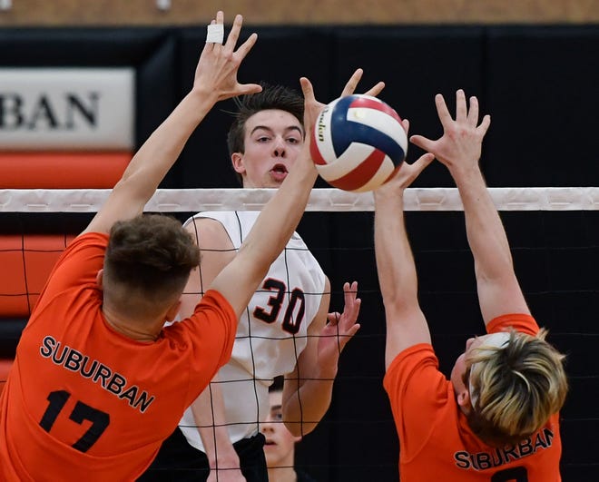 Joel Braswell of Northeastern hammers a kill past Harrison, Perring, left, and Noah Chojnacki of York Suburban, Tuesday, April 8, 2019.
John A. Pavoncello photo