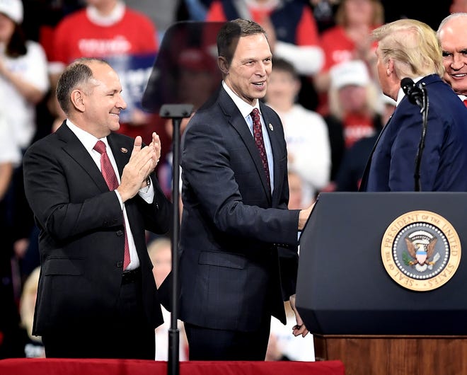 U.S. Congressmen Lloyd Smucker, left, and Scott Perry take the stage with President Donald Trump, right, at a "Keep America Great" rally at the Giant Center in Hershey Tuesday, Dec. 10, 2019. Bill Kalina photo
