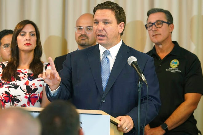 In this Aug. 10, 2021, photo, Florida Gov. Ron DeSantis answers questions related to school openings and the wearing of masks in Surfside, Fla. Top Republicans are battling school districts in their own statesâ€™ urban, heavily Democratic areas over whether students should be required to mask up as they head back to school. (AP Photo/Marta Lavandier)
