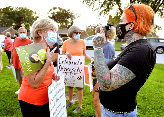 Retired Central School District teacher Kathy Kot, left, talks with Amelia McMillan during a demonstration outside the Central York School District Administration offices before a school board meeting there Monday, Sept. 13, 2021. The rally was in opposition to a banned resource list instituted by the district, which demonstrators say targets minority authors. Amelia is running for a seat on the Central York District School Board in the upcoming election. Bill Kalina photo