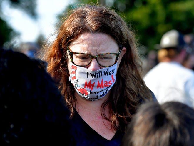 Lancaster School District teacher Rebecca Anderson wears a mask referencing a Dr. Seuss book during a rally outside the Central York School District Administration offices before a school board meeting there Monday, Sept. 20, 2021. She attended to show support to the opposition to a banned resource list instituted by the district, which demonstrators say targets minority authors. District officials added formal discussion of the ban to Monday's agenda. Bill Kalina photo