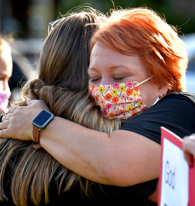 Central York School District music teachers Katy Naimoli, left, and Jill Beck embrace during a rally outside the Central York School District Administration offices before a school board meeting there Monday, Sept. 20, 2021. The rally was in opposition to a banned resource list instituted by the district, which demonstrators say targets minority authors. District officials added formal discussion of the ban to Monday's agenda. Bill Kalina photo