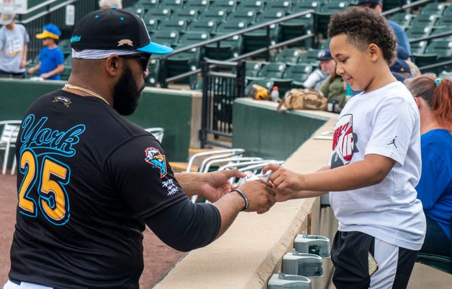 York Revolution's Nellie Rodriguez (25), on left, signing a baseball for Zeiden Smith (10), from Wrightsville, on right,  at the Fan Fest at WellSpan Park in York on Saturday, Apr. 22, 2023.