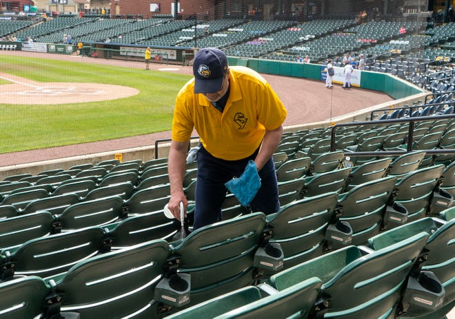 Keith Grim cleaning the chairs before the gates opened at York Revolution's Fan Fest at WellSpan Park in York on Saturday, Apr. 22, 2023.